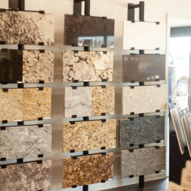 Granite countertop samples on showroom display rack, C&A Roofing & Construction