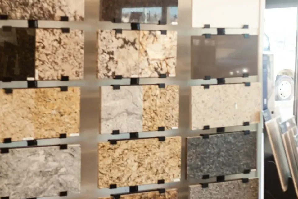 Granite countertop samples on showroom display rack, C&A Roofing & Construction