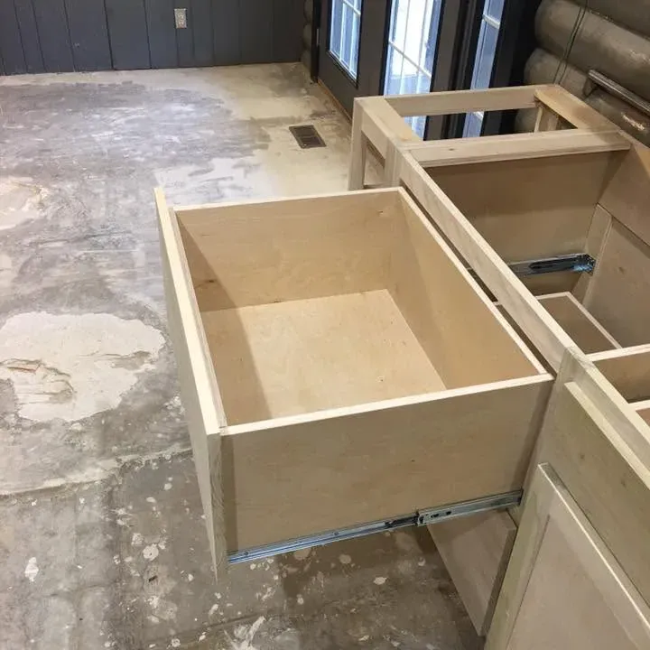 Unfinished kitchen base cabinet boxes being installed, C&A Roofing & Construction