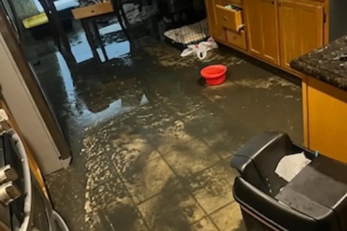 Kitchen floor flooded with water damage, C&A Roofing & Construction