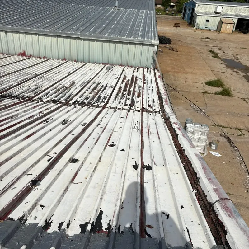 Commercial corrugated metal roof partly coated, peeling sections, C&A Roofing & Construction