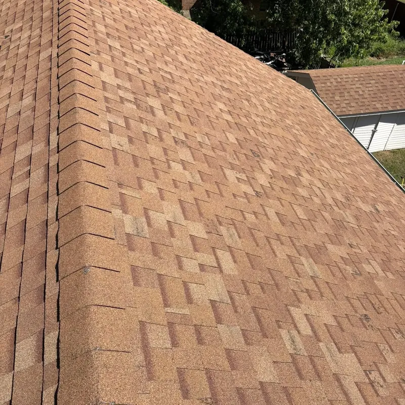 Brown architectural shingles along hip ridge close-up, C&A Roofing & Construction