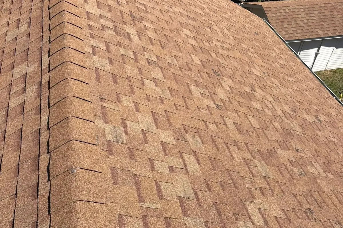 Brown architectural shingles along hip ridge close-up, C&A Roofing & Construction