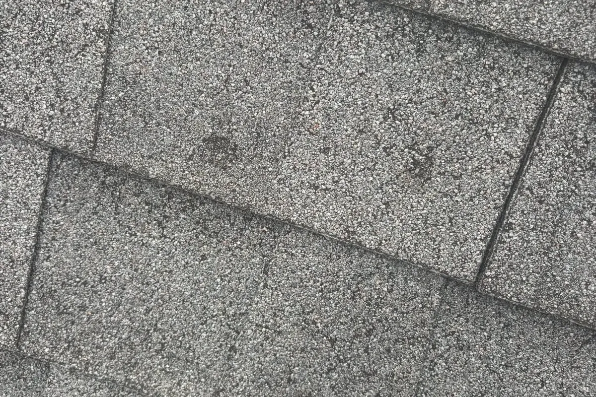 Close-up of worn gray asphalt shingles, C&A Roofing & Construction