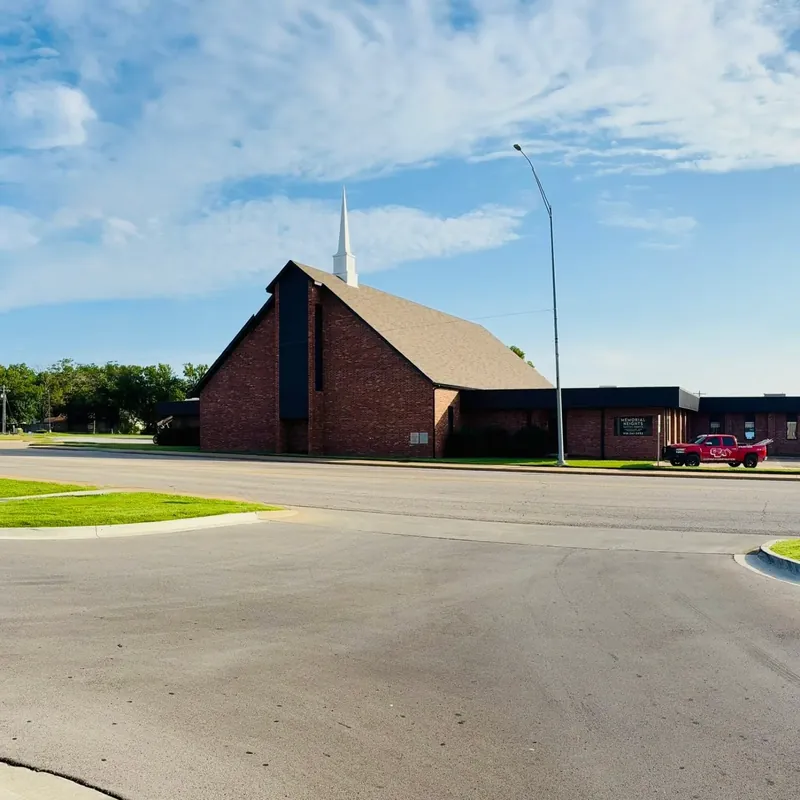 Wide shot of brick church with new shingle roof, C&A truck, C&A Roofing & Construction