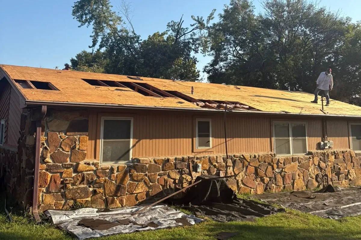 Stone ranch house with roof stripped to decking, C&A Roofing & Construction