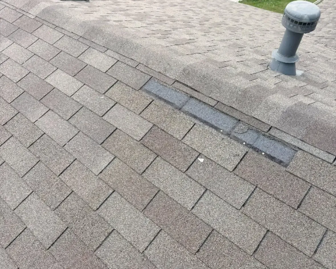 Gray shingle roof with damaged ridge vent and pipe vent, C&A Roofing & Construction