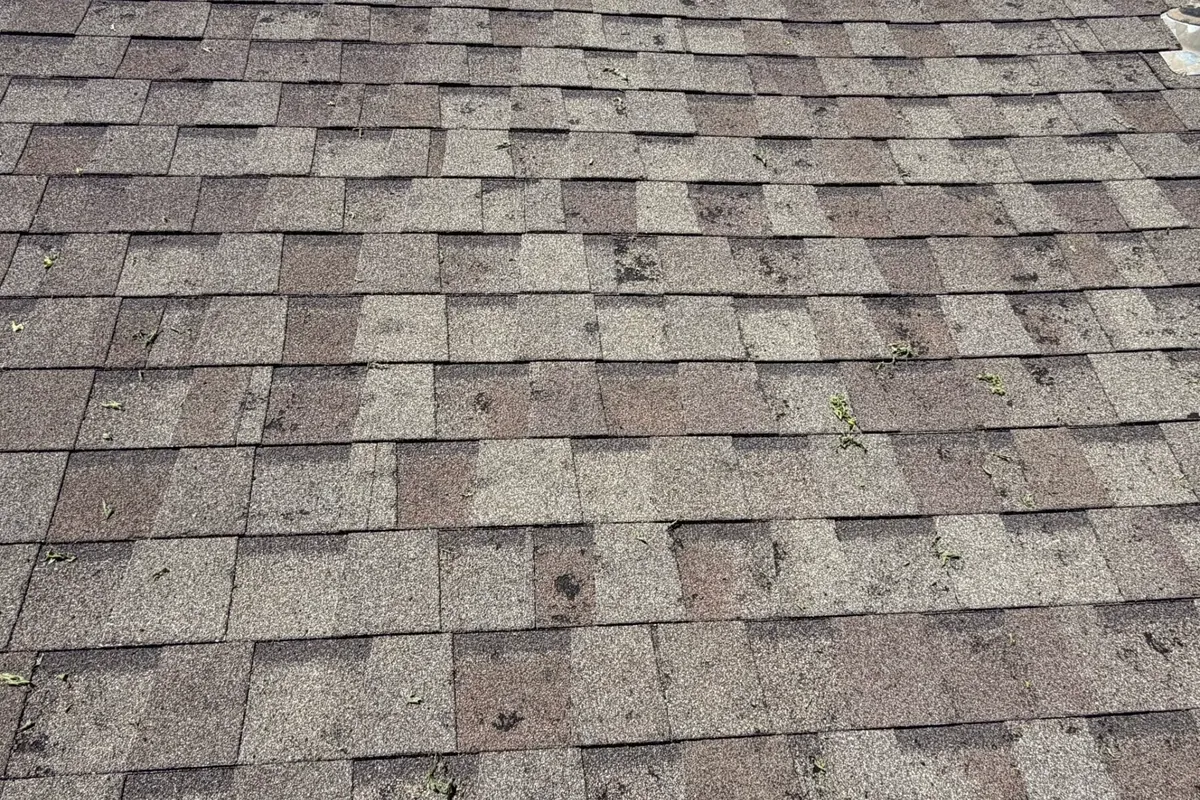Close-up of worn brown shingles with granule loss, C&A Roofing & Construction