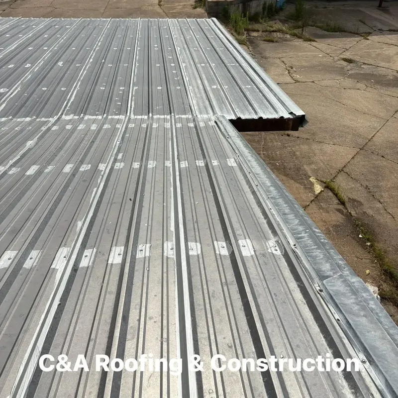 New galvanized metal roof panels on long building, C&A Roofing & Construction