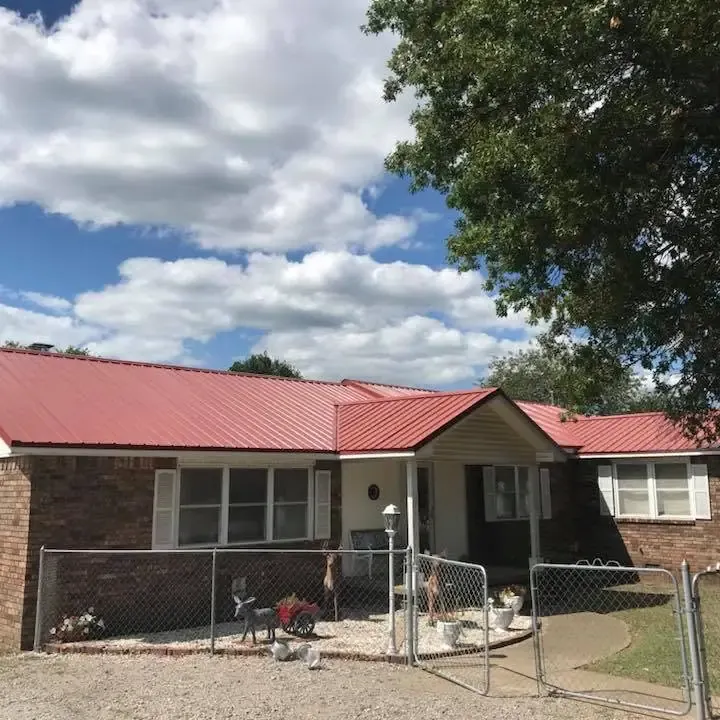 Brick ranch house with new red metal roof, C&A Roofing & Construction