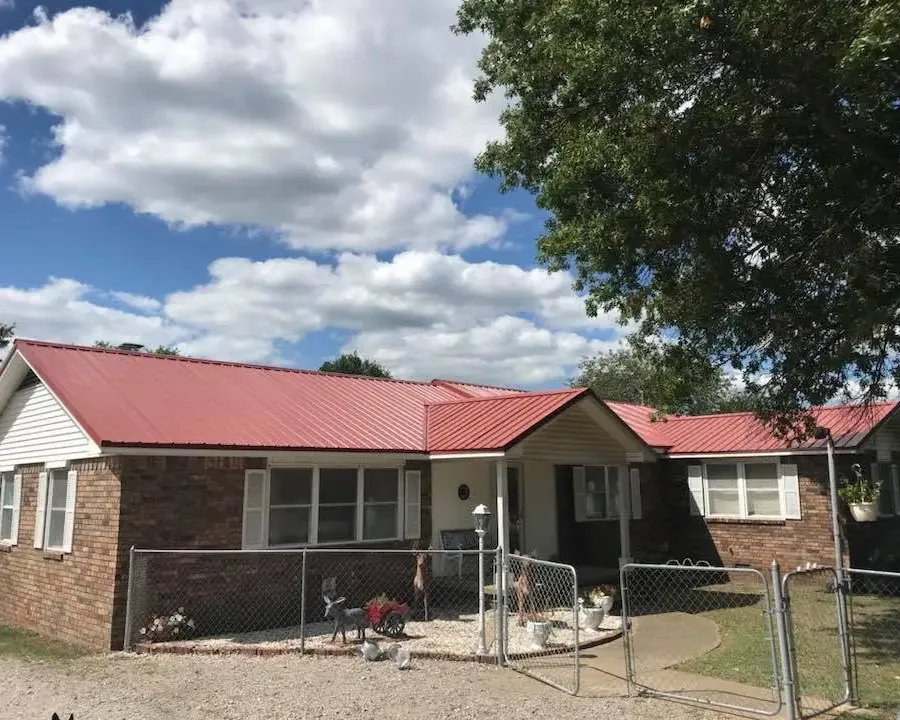 Brick ranch house with new red metal roof, C&A Roofing & Construction