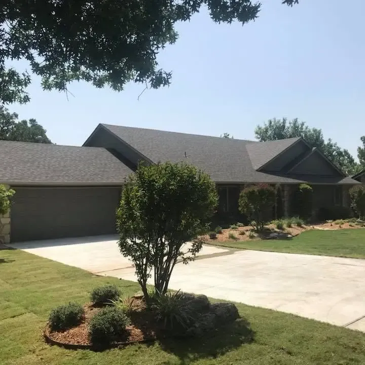 Brick ranch home with shingle roof and long driveway, C&A Roofing & Construction