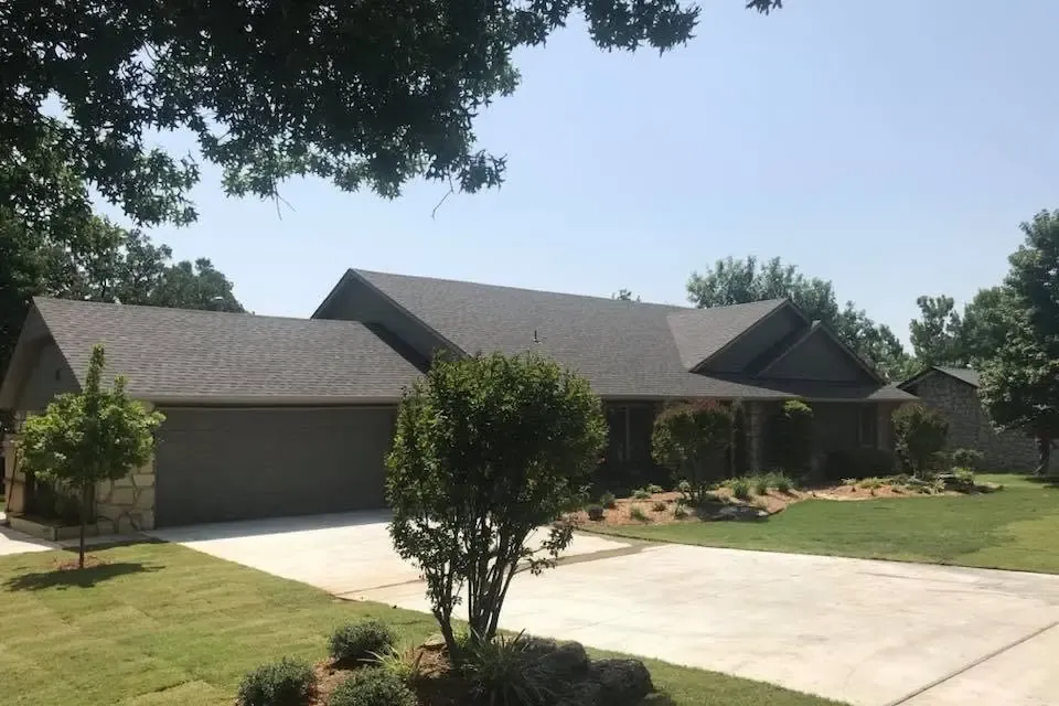 Brick ranch home with shingle roof and long driveway, C&A Roofing & Construction