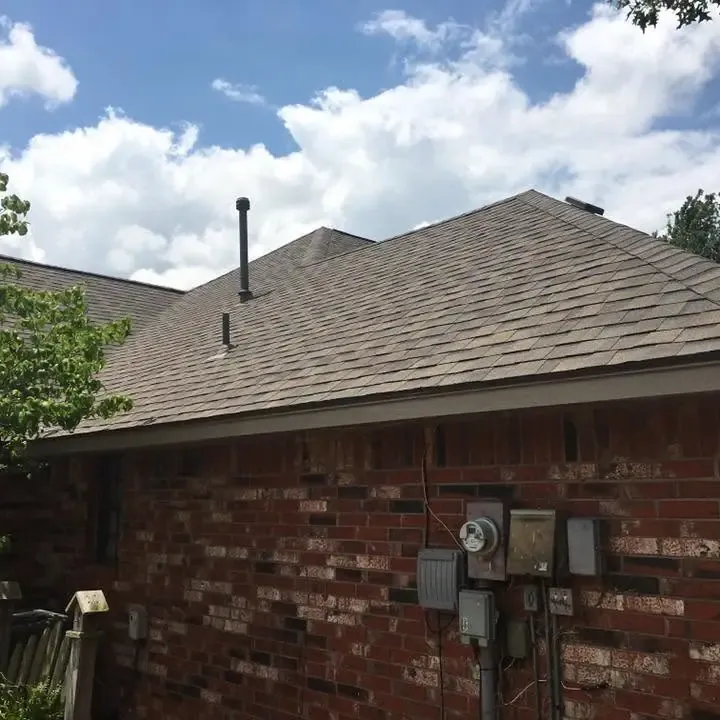 Brick house with new shingle roof, close side view, C&A Roofing & Construction