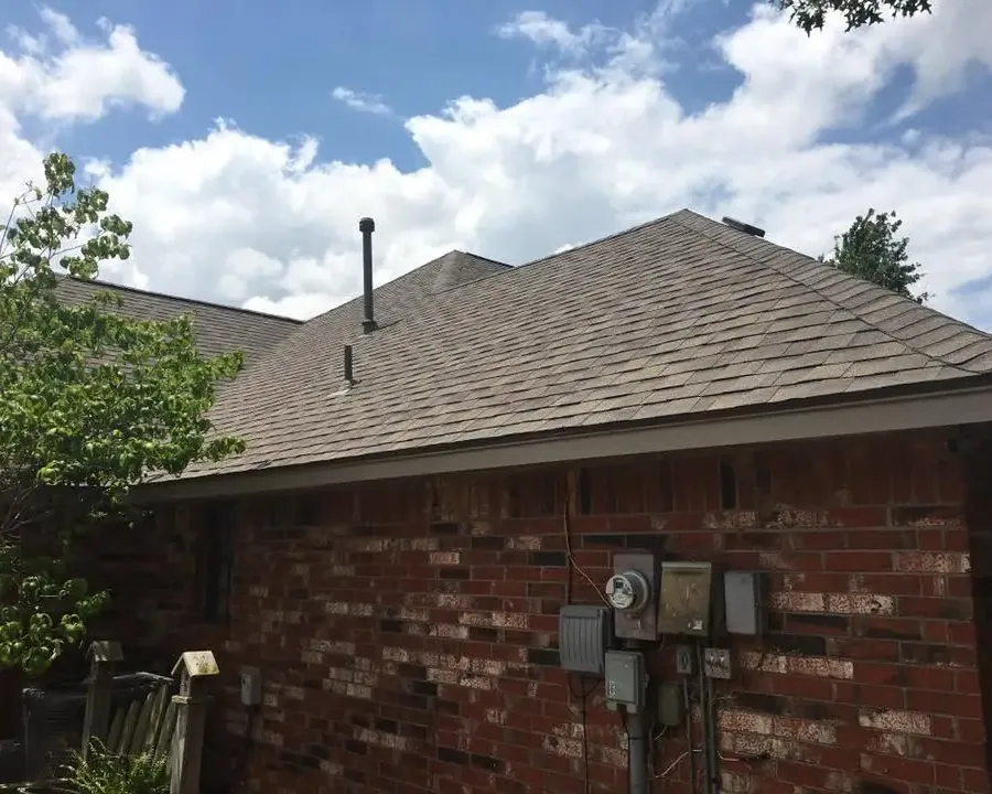 Brick house with new shingle roof, close side view, C&A Roofing & Construction