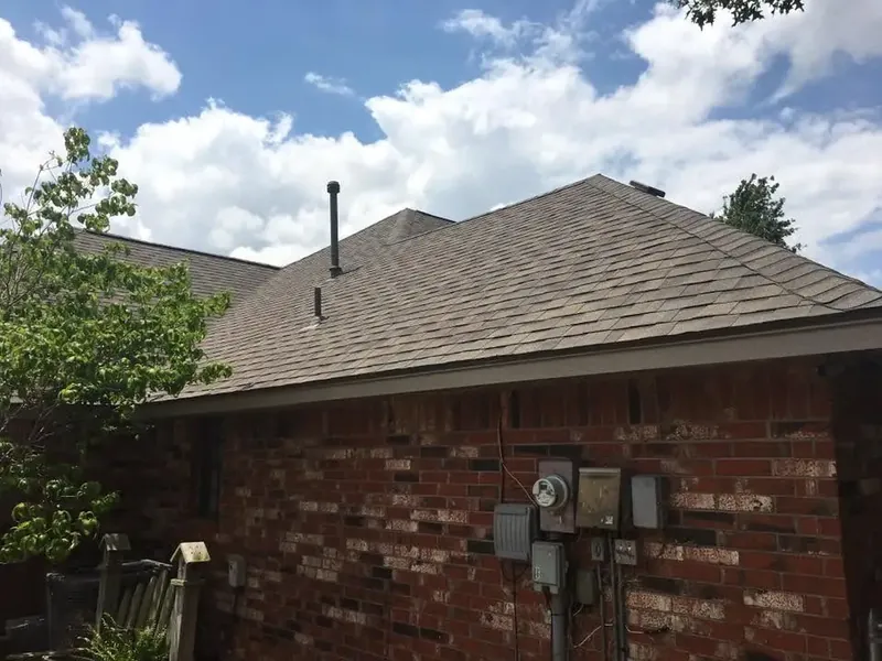 Brick house with new shingle roof, close side view, C&A Roofing & Construction