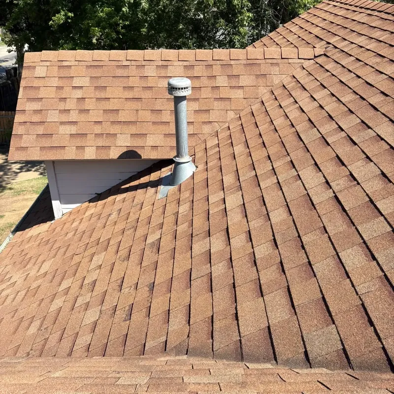 Close-up of brown shingle roof with pipe vent, C&A Roofing & Construction