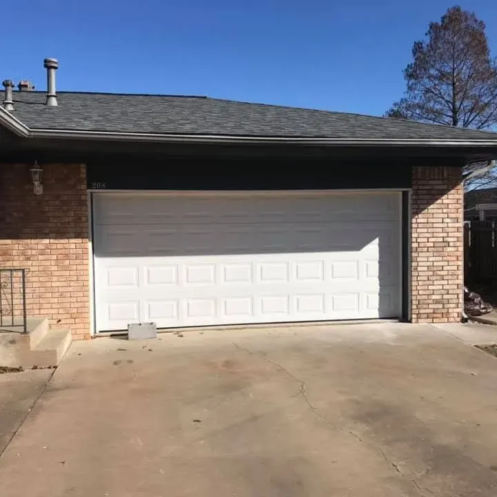 Brick house garage with dark shingle roof, C&A Roofing & Construction
