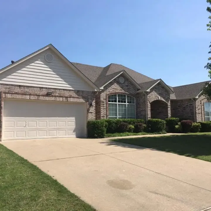 Brick house with shingle roof and two-car garage, C&A Roofing & Construction