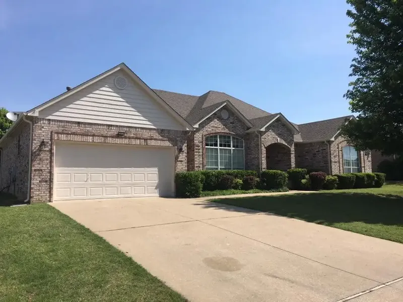 Brick house with shingle roof and two-car garage, C&A Roofing & Construction