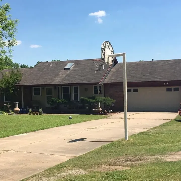 Brick ranch with dark shingle roof and small skylight, C&A Roofing & Construction