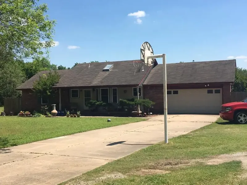Brick ranch with dark shingle roof and small skylight, C&A Roofing & Construction