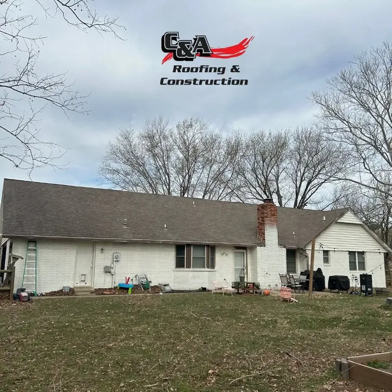 White ranch house with shingle roof and chimney, C&A Roofing & Construction