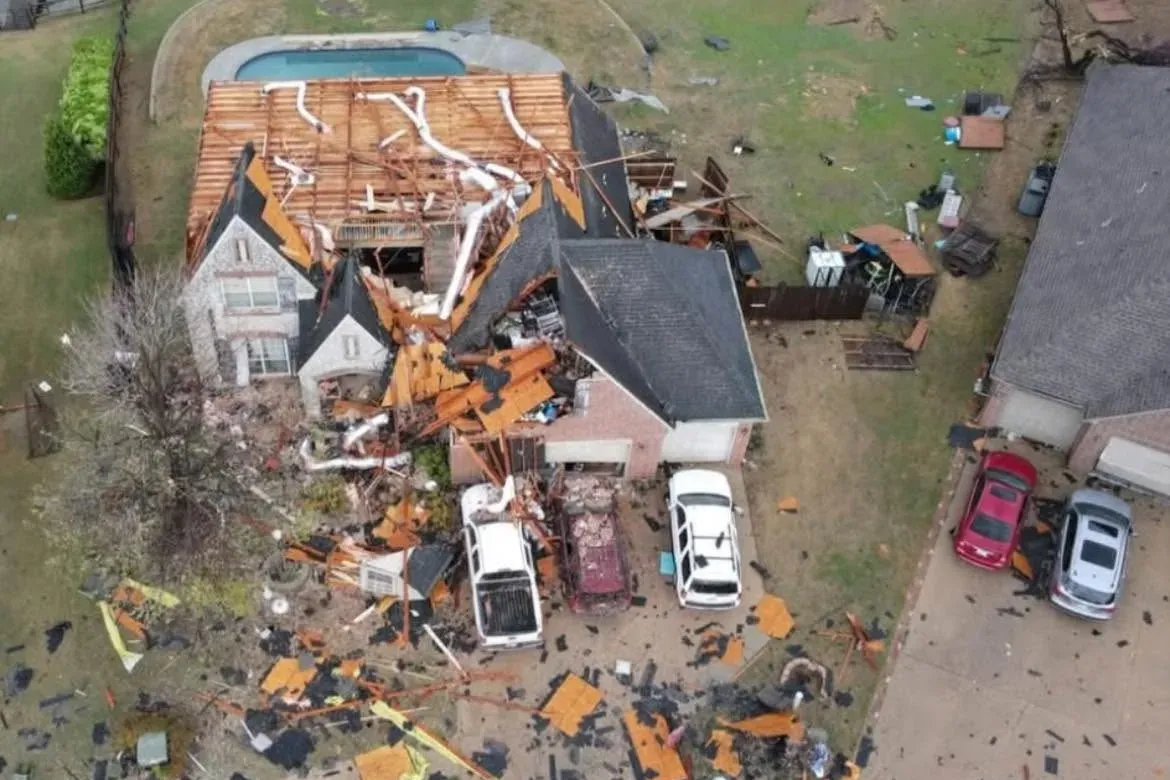 Aerial view of tornado-destroyed house with debris field, C&A Roofing & Construction