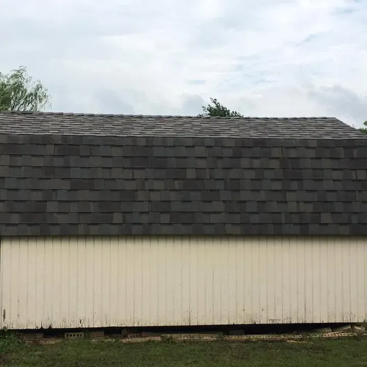Storage shed with new dark shingle roof, C&A Roofing & Construction