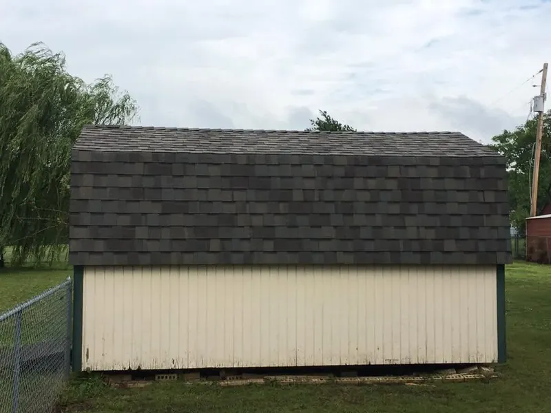 Storage shed with new dark shingle roof, C&A Roofing & Construction