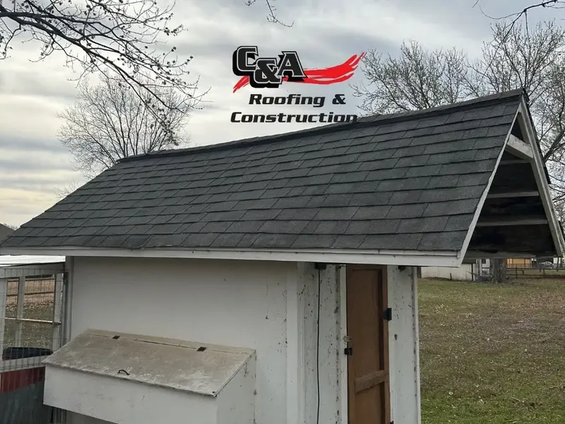 Small shed with newly installed dark shingles, C&A Roofing & Construction