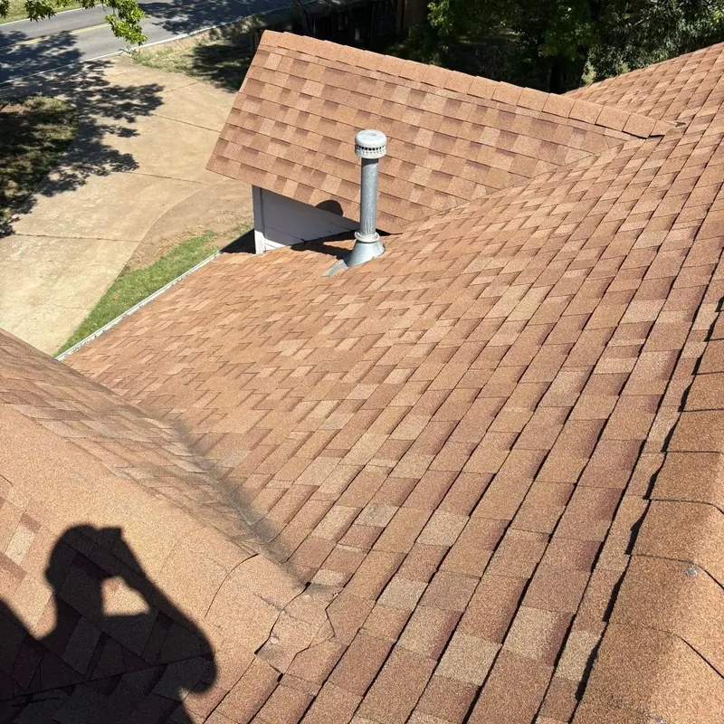 Brown shingle roof slope with pipe vent from rooftop, C&A Roofing & Construction