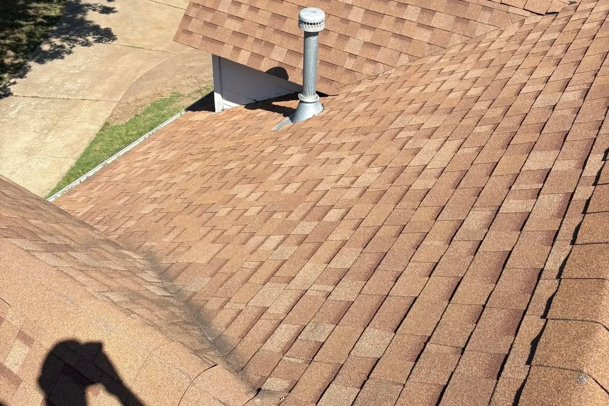 Brown shingle roof slope with pipe vent from rooftop, C&A Roofing & Construction