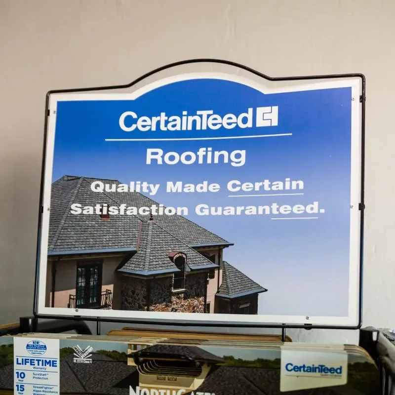 CertainTeed Roofing sign display with shingle samples, C&A Roofing & Construction