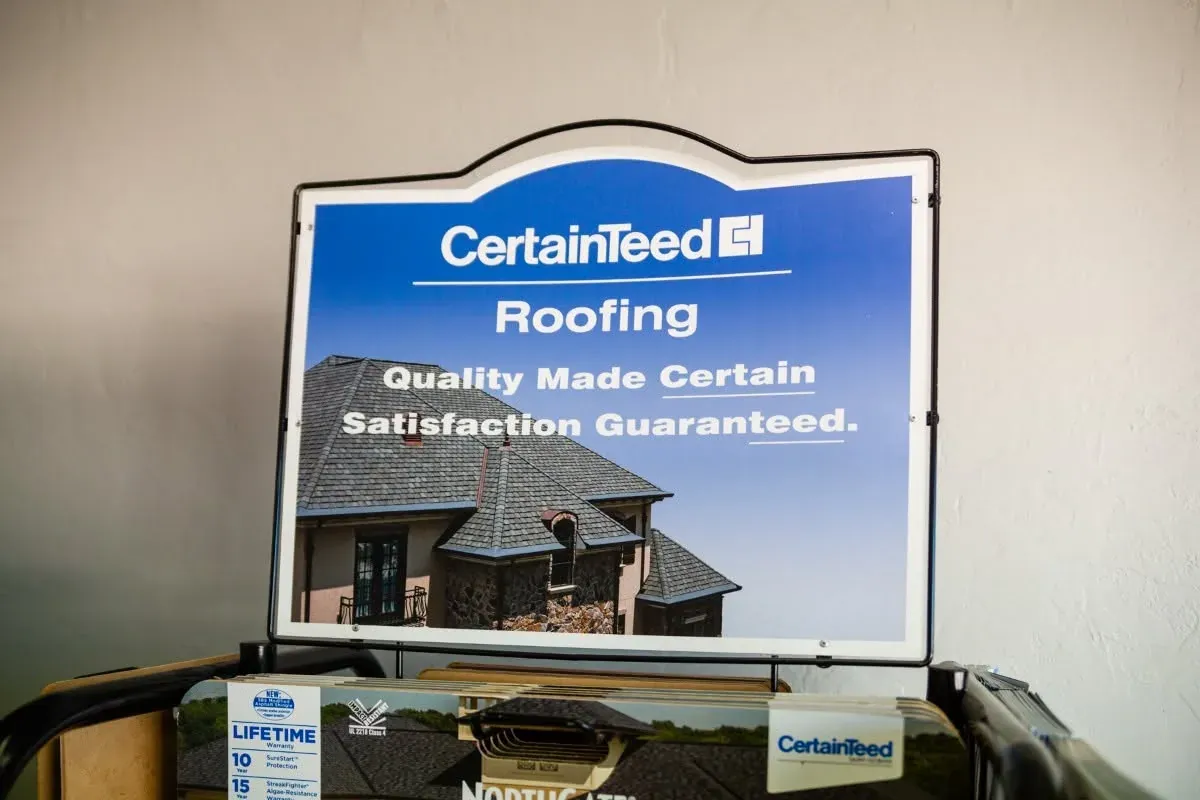 CertainTeed Roofing sign display with shingle samples, C&A Roofing & Construction