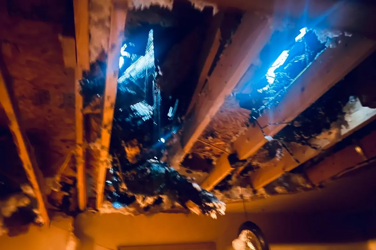 Damaged ceiling with holes showing daylight through roof, C&A Roofing & Construction