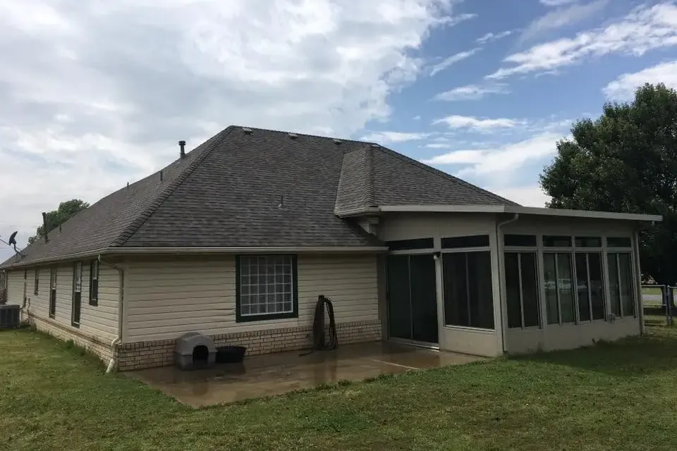 Ranch house with shingle roof and screened sunroom, C&A Roofing & Construction